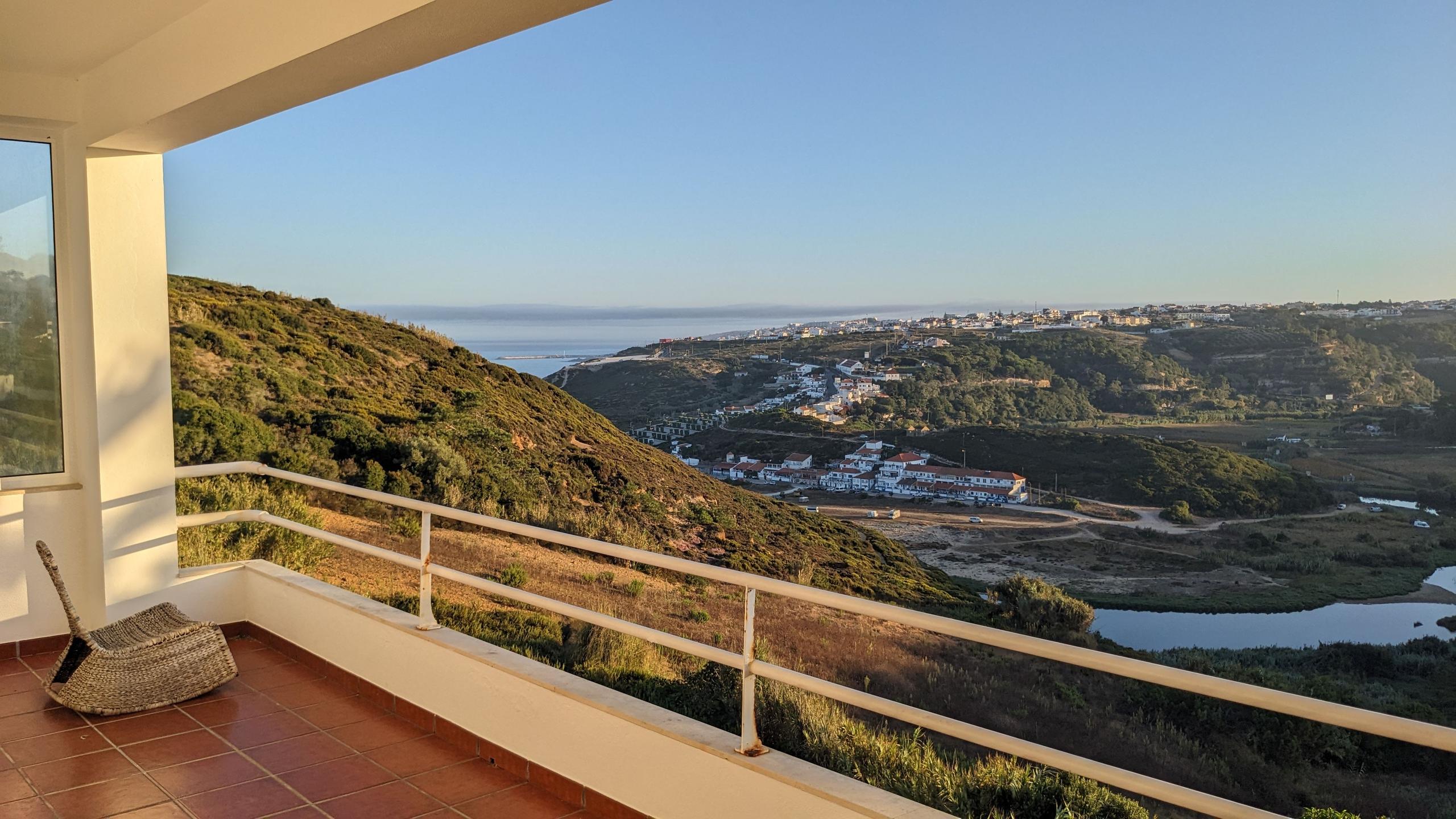 View from the balcony overlooking the valley, Ericeira town and the ocean in the distance