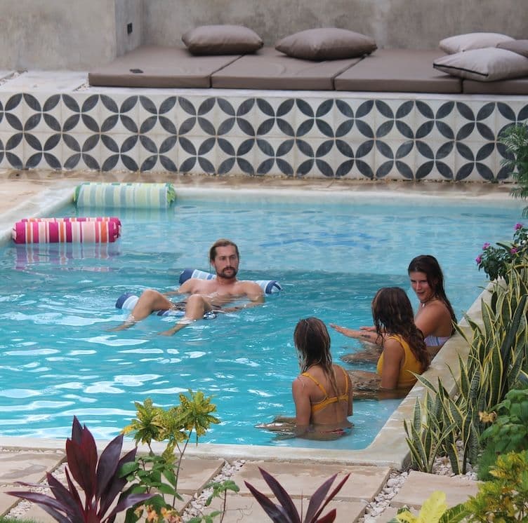 Guests socializing in the pool at Waves & Wifi