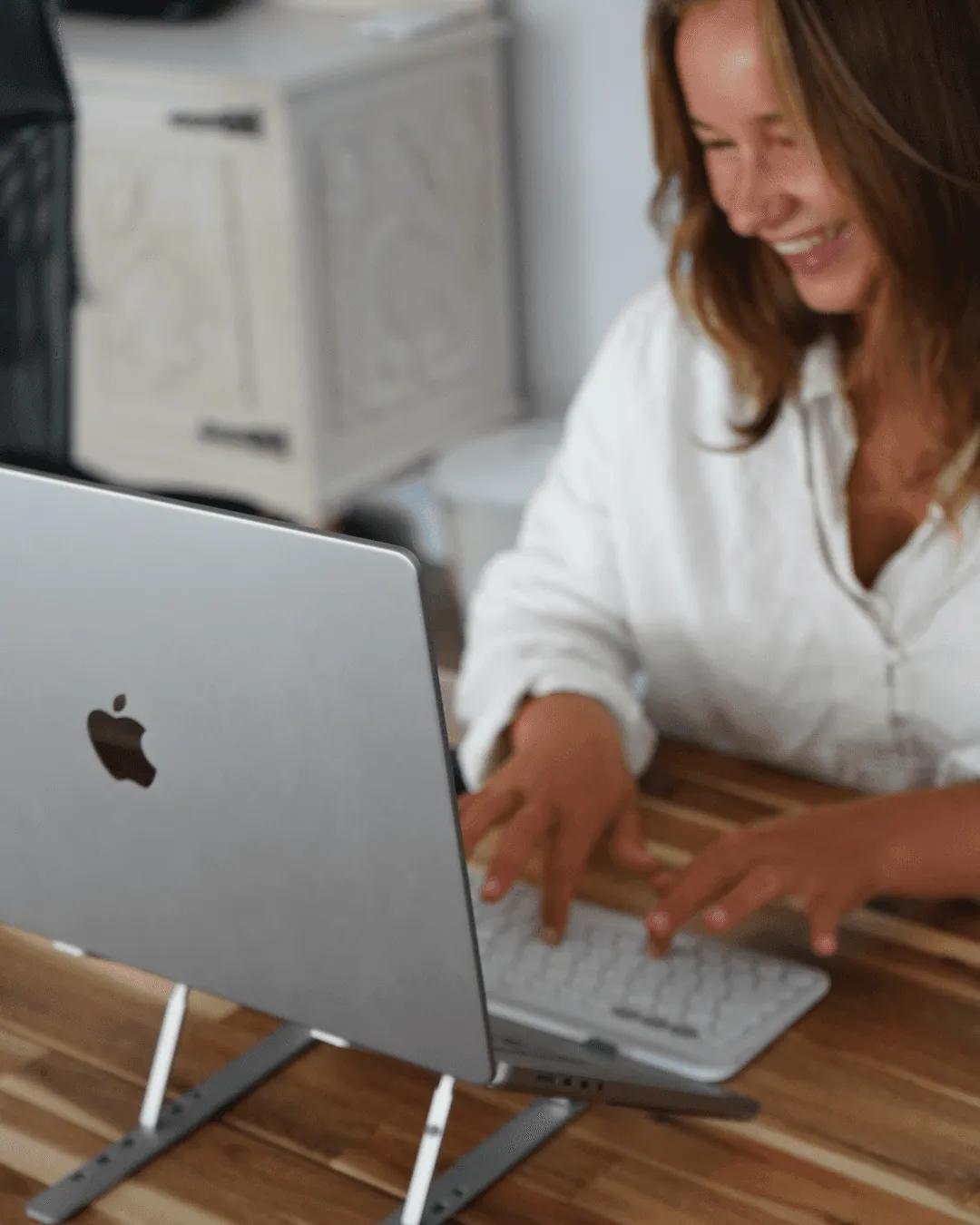 Person working on a laptop at a desk in the coworking space