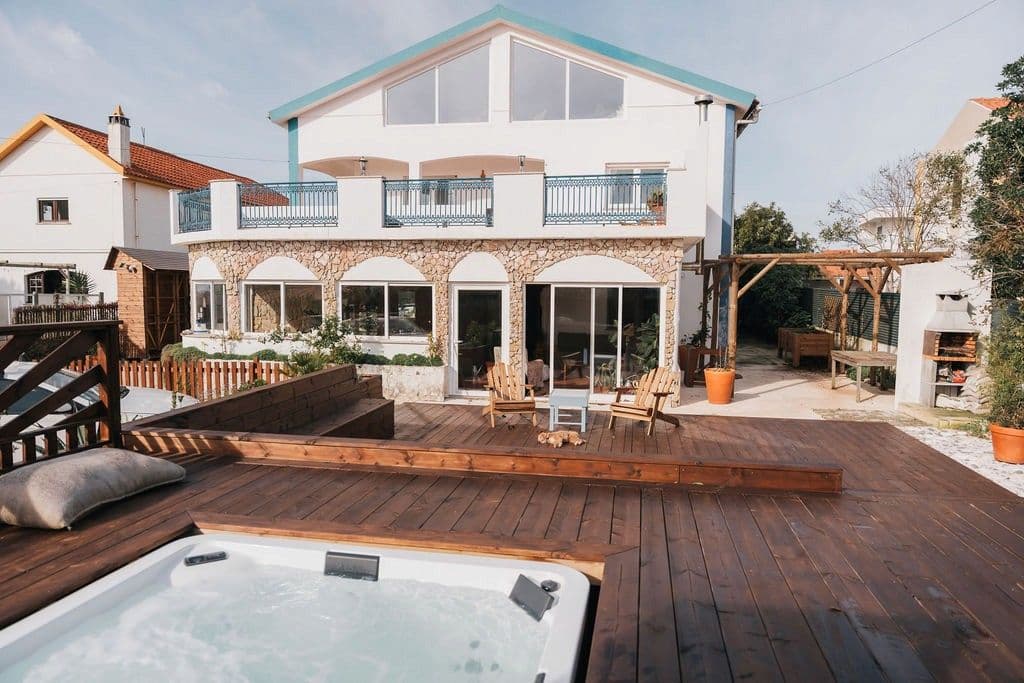 The outdoor deck with jacuzzi and view of the Wild Souls house exterior