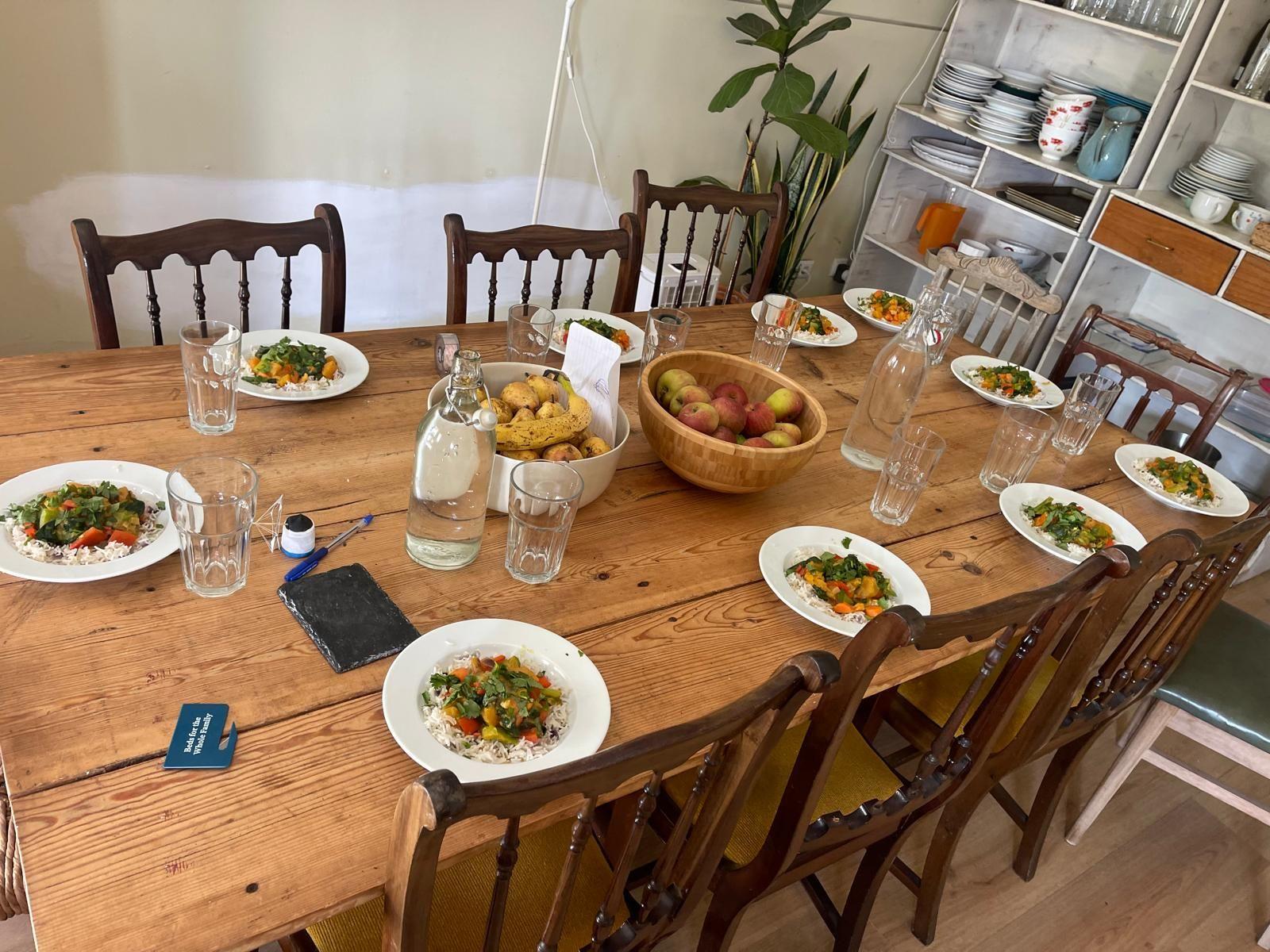 Photo of rustic dinner table set with a full meal for digital nomads