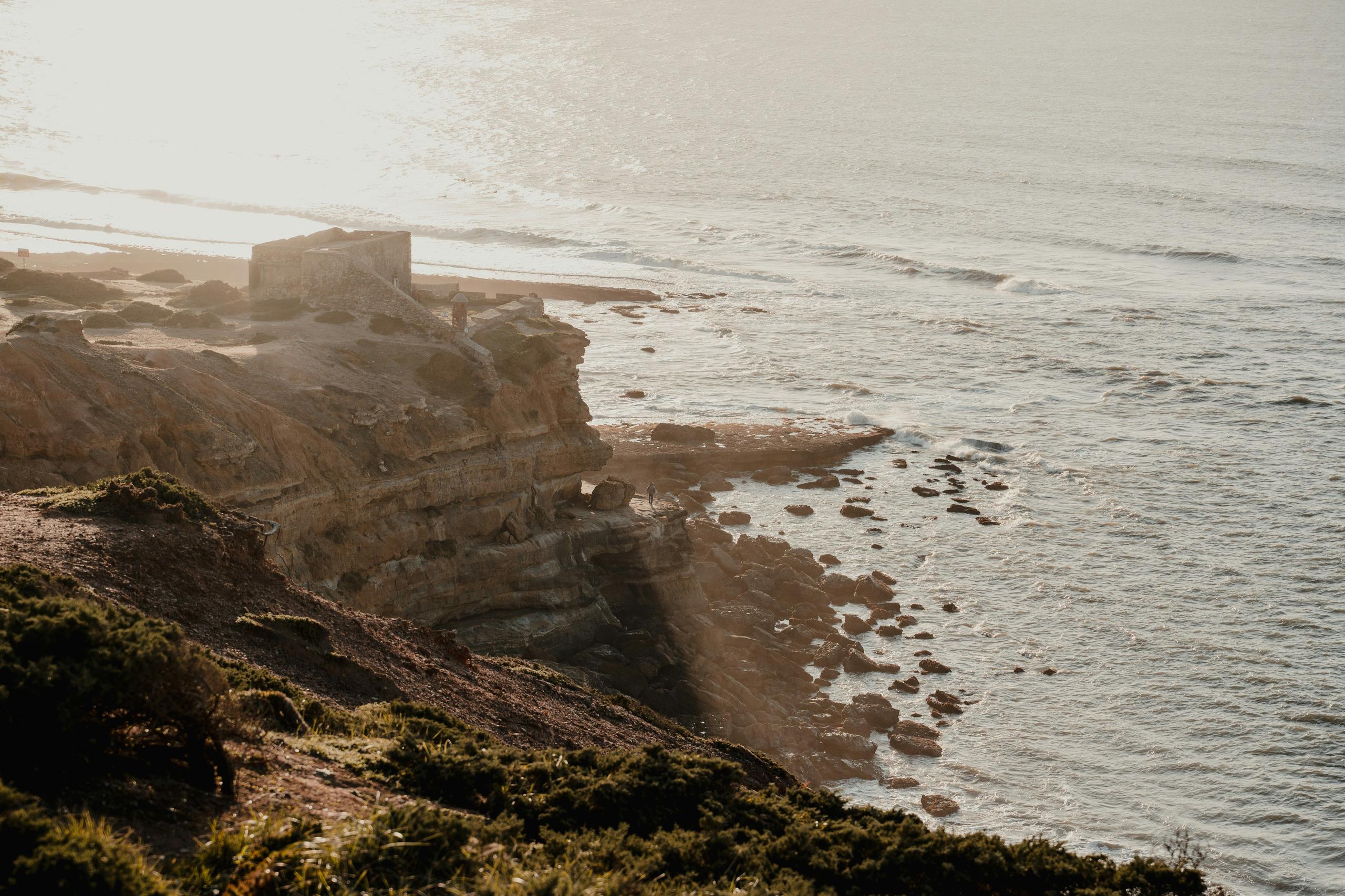 Aerial view of cliffside at Ericeira beach near Wild Souls Coliving in Portugal